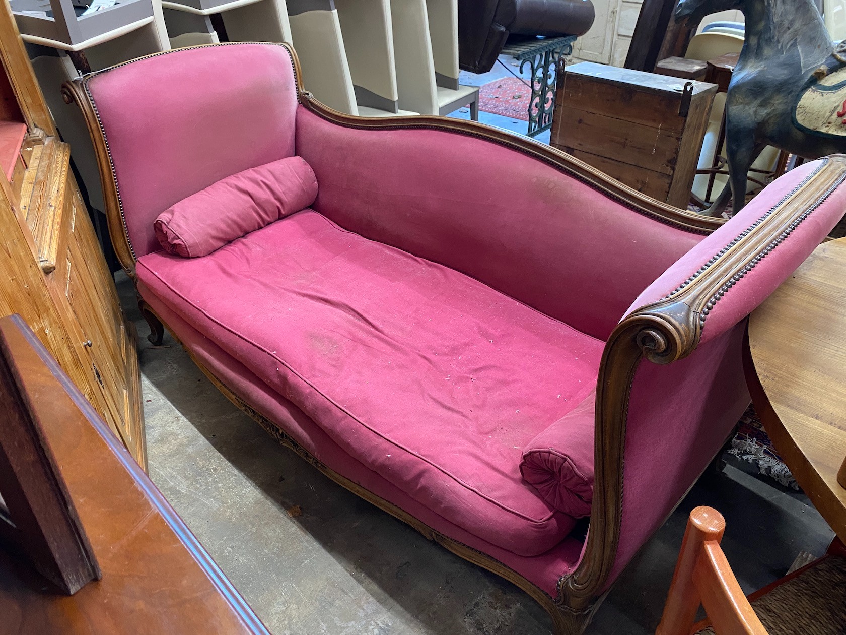 An early 20th century Continental carved beech scroll end settee, length 204cm, width 84cm, height 99cm